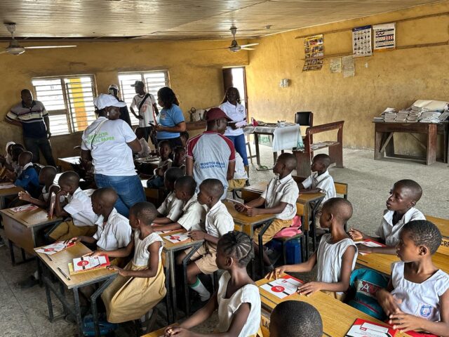 Presenting gifts to the students of LA Government Primary School Ajegunle